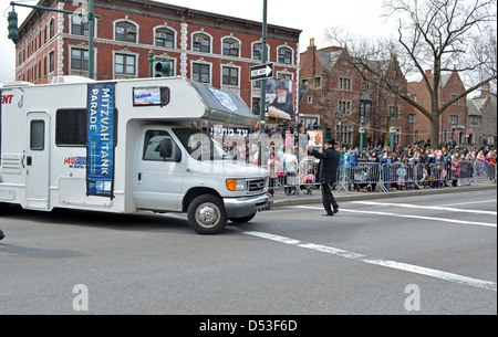 Mitzvah Tanks parading past Lubavitch headquarter to celebrate the birthday of the Lubavitcher Rebbe Menachem Mendel Schneerson. Stock Photo