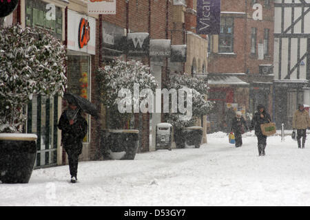 Chesterfield, Derbyshire, UK. 23rd March 2013. 23rd March 2013. Shoppers brave snowy weather, Vicar Lane, Chesterfield, Derbyshire. UK.  Credit:  Matthew Taylor / Alamy Live News Stock Photo