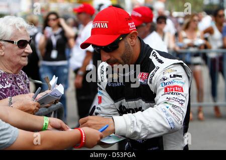 St. Petersburg, Florida, USA. 23rd March 2013. Tony Kanaan signs autographs for fans outside of pit lane before the start of afternoon qualifying sessions. (Credit Image: Credit:  Luis Santana/Tampa Bay Times/ZUMAPRESS.com/Alamy Live News) Stock Photo