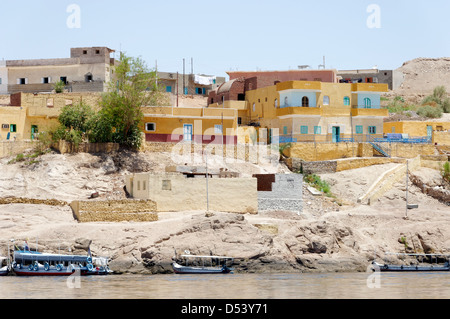 Aswan. Egypt. View of colourful Nubian houses beside the River Nile. Stock Photo