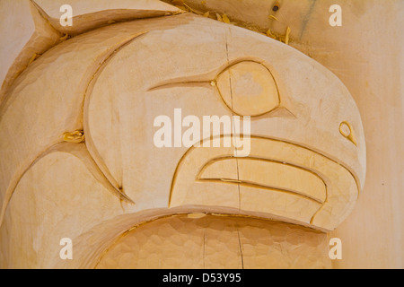 Close-up feature of a fish head on a newly carved totem pole Stock Photo