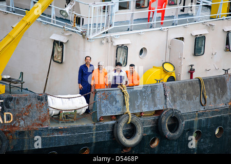 Tug Assisting the Nicobar Ferry From Mumbai,India calling at Port Blair packed with Passengers from the mainland,Andaman Islands Stock Photo