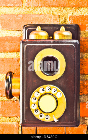 Old phone on the wall Stock Photo