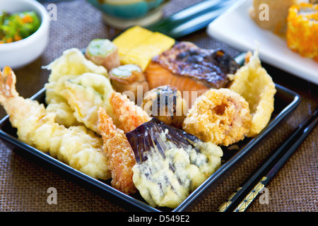 Japanese Bento set contain varieties of vegetables and fish in batter with Nori maki Stock Photo