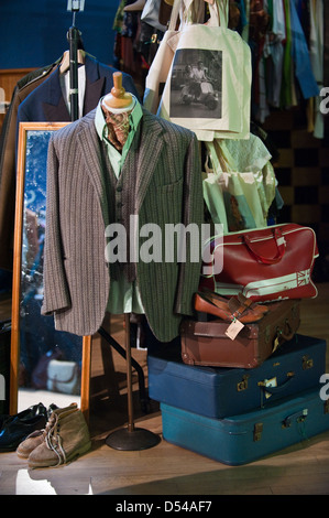 Retro men's jacket, waistcoat and shirt with old 1960s suitcases on display at a vintage market, flea stall Stock Photo