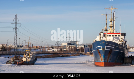 Ships moored in icy harbor. Cargo port of St.Petersburg, Russia Stock Photo