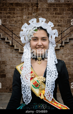 Spanish Girl in Traditional Costume including lace mantilla  veil or shawl during las Fallas or Falles festival in Valencia Spain Stock Photo