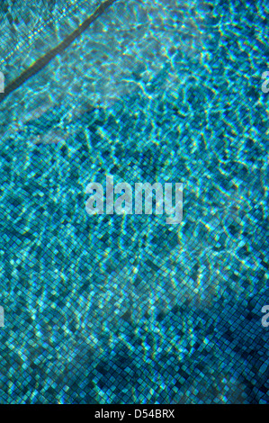 rippling blue water in swimming pool with light refracting Stock Photo