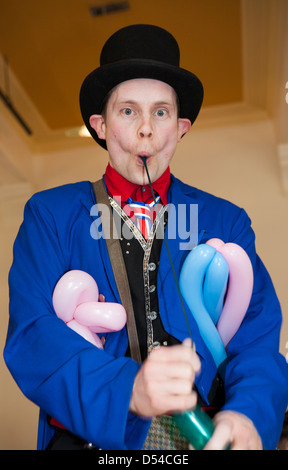 Balloon Modeller Inflating balloons at the 5th Annual Chocolate Festival, held in Bridge Street, Ramsbottom, Lancashire, UK, UK Stock Photo
