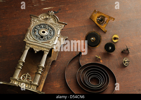 Old broken watches and parts to the clock on a wooden surface Stock Photo