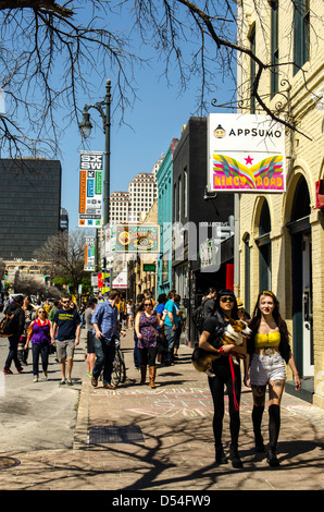 People walking around the 6th Street during SXSW Music festival Austin Texas US Stock Photo