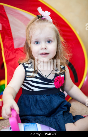 Happy small child playing in domestic room Stock Photo