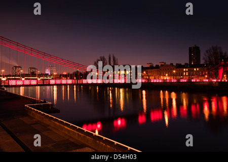 The St Andrews Suspension Bridge in Glasgow at night an iron footbridge crosses the River Clyde in the centre of Glasgow It was Stock Photo