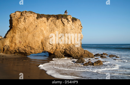 Visitor atop formation at El Matador State Beach in Southern California Stock Photo