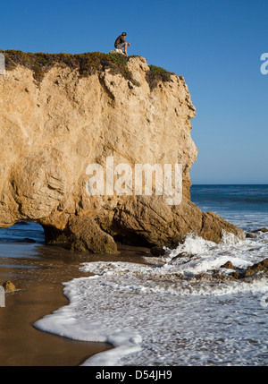 Visitor atop formation at El Matador State Beach in Southern California Stock Photo