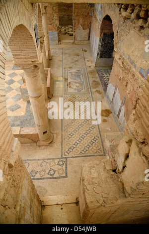 Arches and mosaic tile floor of interior Slope House ruin on Curetes street of ancient Ephesus Turkey Stock Photo