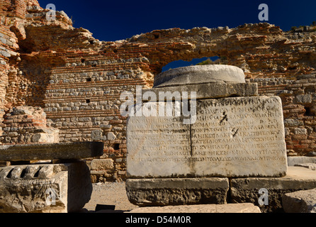 Greek inscription on stone column base at the brothel wall at Curetes and Marble streets of ancient Ephesus Turkey Stock Photo