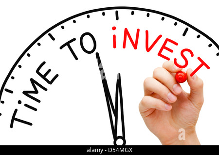 Hand writing Time to Invest concept with red marker on transparent wipe board. Stock Photo