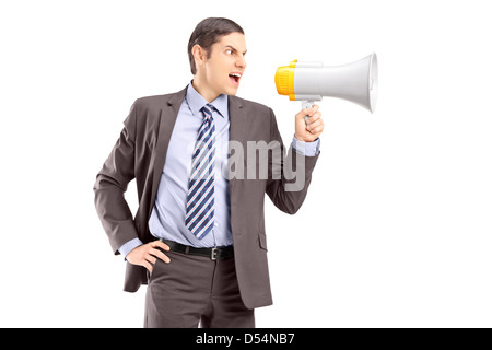 An angry young businessman announcing via megaphone isolated against white background Stock Photo