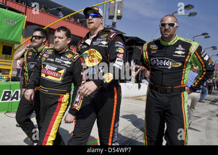 Fontana, California, USA. 24th March 2013. March 25, 2013 - Fontana, California, U.S - Crew members from competing teams escort an angry Tony Stewart back to his pit after a post-race altercation with Joey Logano at the Auto Club 400 NASCAR race in Fontana. (Credit Image: Credit:  Daniel Knighton/ZUMAPRESS.com/Alamy Live News) Stock Photo