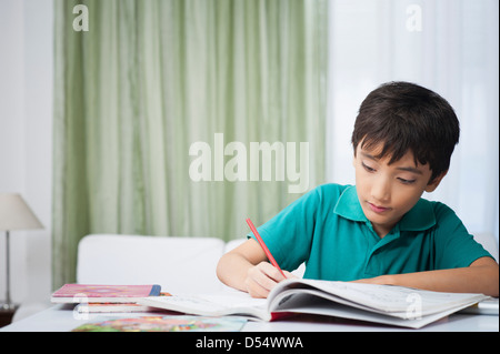 Boy doing his homework Stock Photo