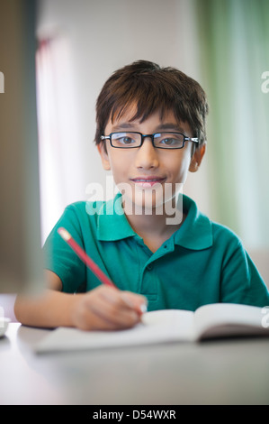 Boy doing his homework Stock Photo