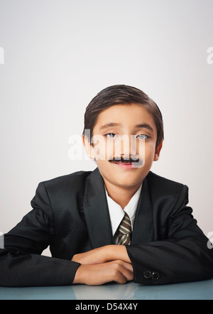 Portrait of a boy imitating like businessman smiling Stock Photo