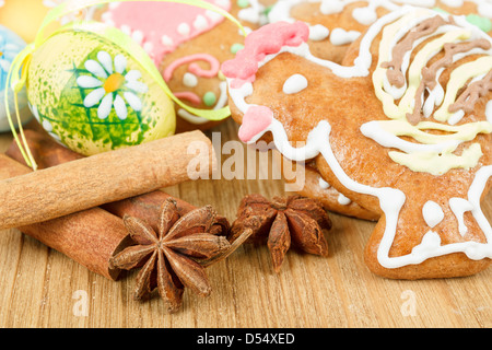 Easter gingerbreads and painted egg on wooden background Stock Photo