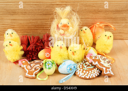 easter decoration, gingerbread, chicken and painted eggs wooden background Stock Photo