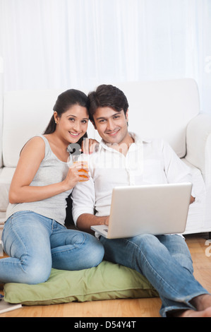 Couple using a laptop and smiling Stock Photo