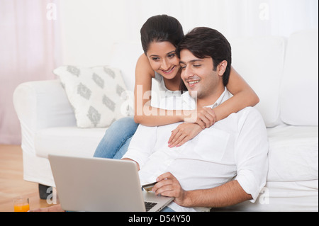 Couple doing online shopping with a laptop Stock Photo