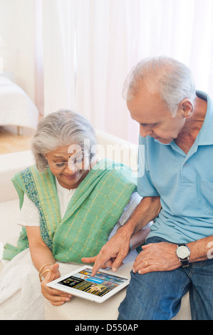 Senior couple using a digital tablet at home Stock Photo