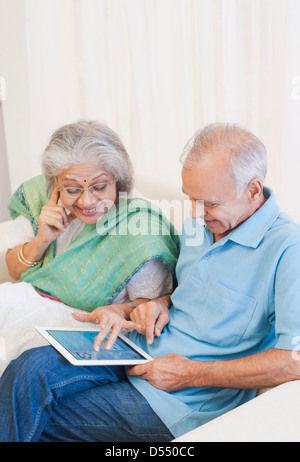 Senior couple using a digital tablet Stock Photo