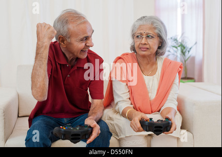 Senior couple playing a video game Stock Photo