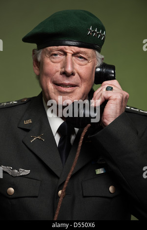 US military general wearing beret. Calling with phone. Studio portrait. Stock Photo