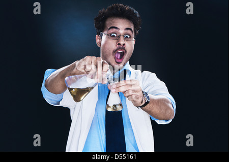 Male scientist experimenting in a laboratory looking surprised Stock Photo