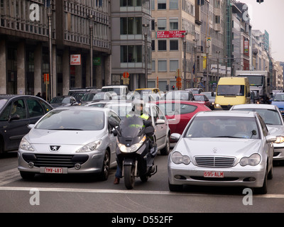 Brussels is one of the most congested cities in Europe and this woman tries to beat the traffic using a motorcycle. Stock Photo