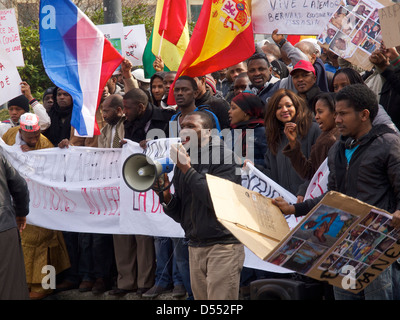People protesting against dictator Alpha Conde of Guinea with signs with pictures of tortured victims. Brussels, Belgium Stock Photo