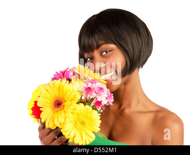 Closeup portrait of gorgeous female with black skin holding in hands great colorful gerber flowers Stock Photo