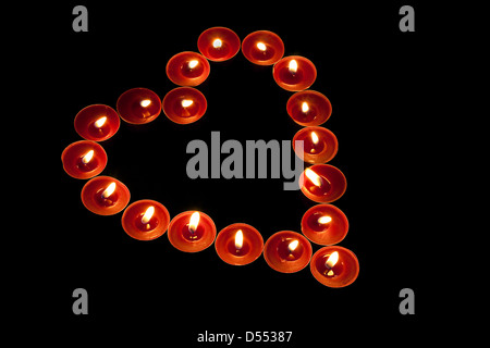 red tealight candles arranged in the shape of a heart good love or valentines day romantic symbol Stock Photo
