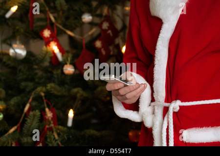 Santa Claus using cell phone Stock Photo