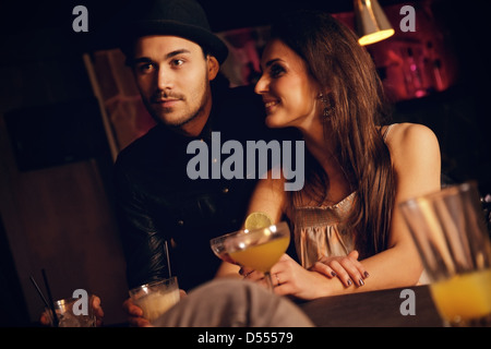 Young couple enjoying their date at the bar with their friends Stock Photo