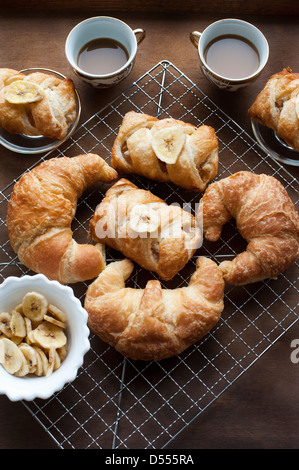 Baked pastries with banana and coffee Stock Photo