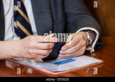 Business man using iphone. Stock Photo