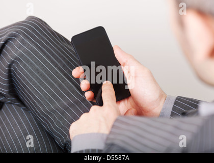 Young adult using mobile smart phone Stock Photo