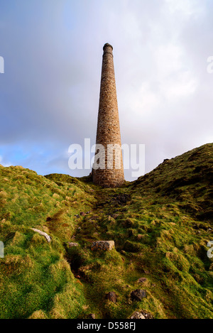 A lone chimney from abondoned tin mines reaches for the sky on Cornwall's rugged West coast, near Land's End.  Stock Photo