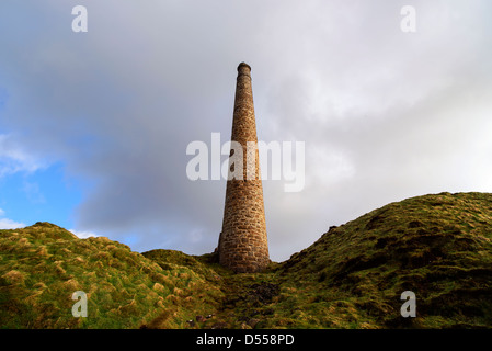 A lone chimney from abondoned tin mines reaches for the sky on Cornwall's rugged West coast, near Land's End.  Stock Photo