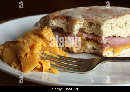 A pease pudding and ham sandwich is served in stottie cake and a side serving of pease pudding. Stock Photo
