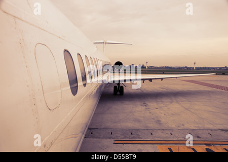 airplane parked in airport waiting for boarding passengers Stock Photo