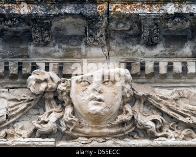 Old stone face carving decoration detail - France. Stock Photo